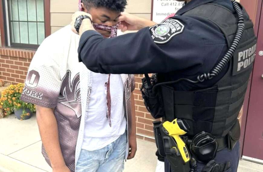 Officers Help Teen Boy Tie His Necktie For His First School Dance