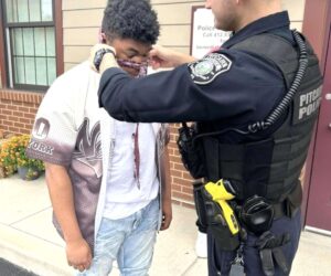 Officers Help Teen Boy Tie His Necktie For His First School Dance